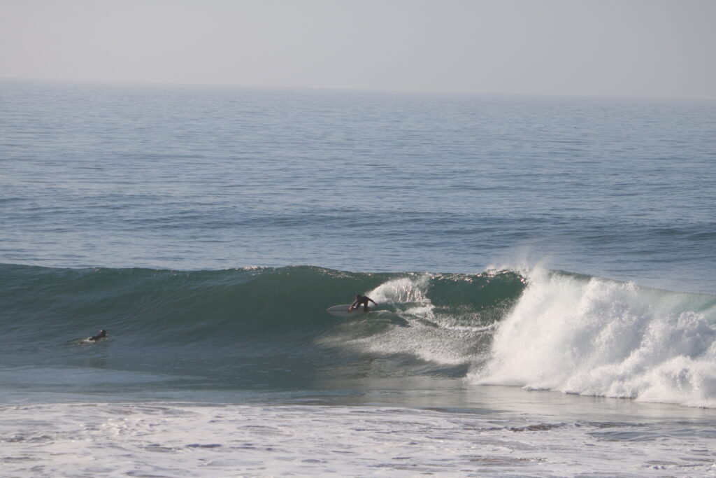 Surfer performing an elegant turn on a 2-meter wave at Banana Point, Morocco, in January.